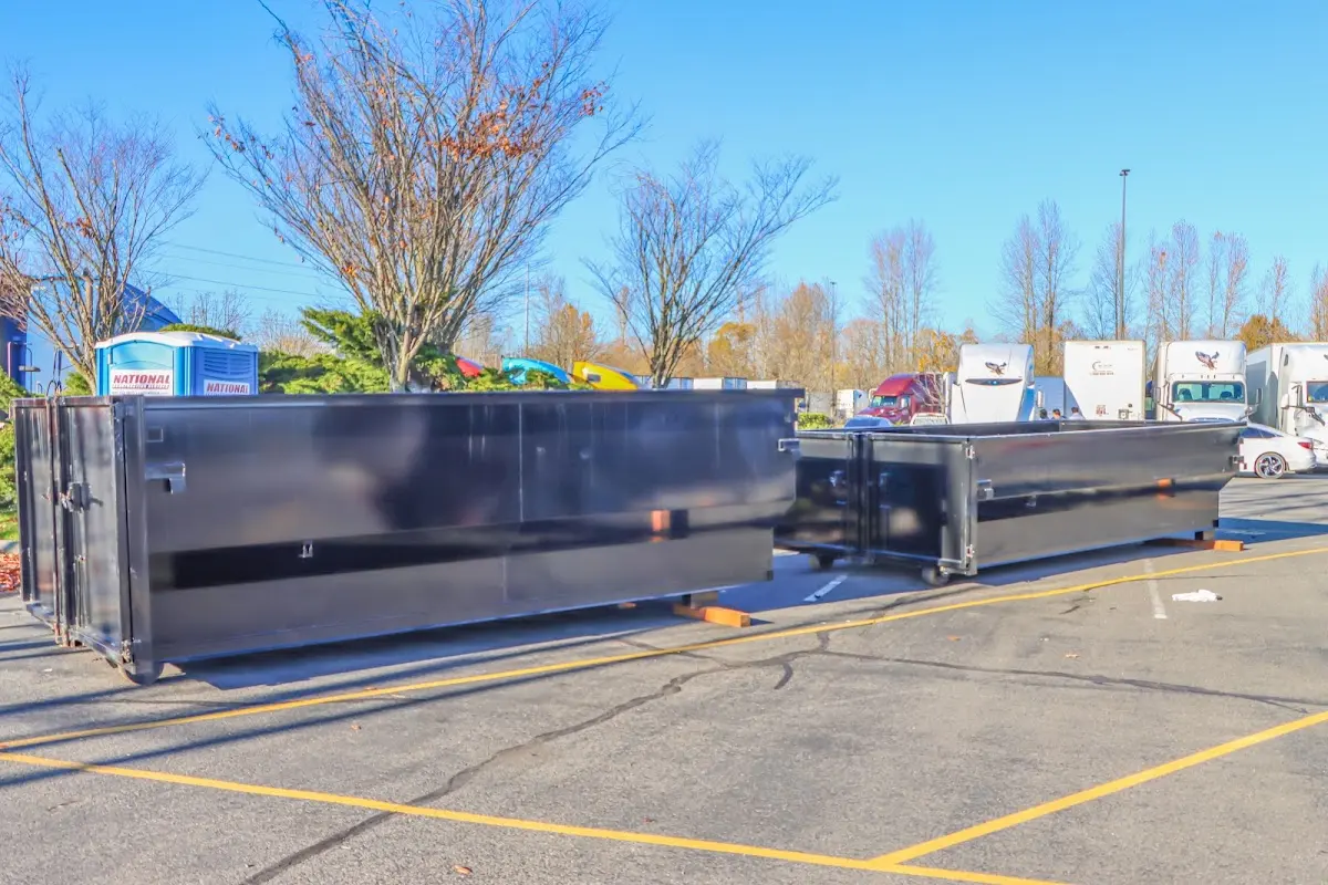 Professional dumpster rental service with roll-off container on residential driveway in Conemaugh